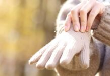 What is Raynaud's disease? A woman putting on woolly gloves