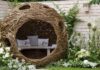 How to make a small garden look bigger: A large natural seating pod surrounded by white planting