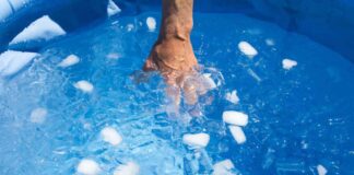 Hand inside ice bath in swimming pool
