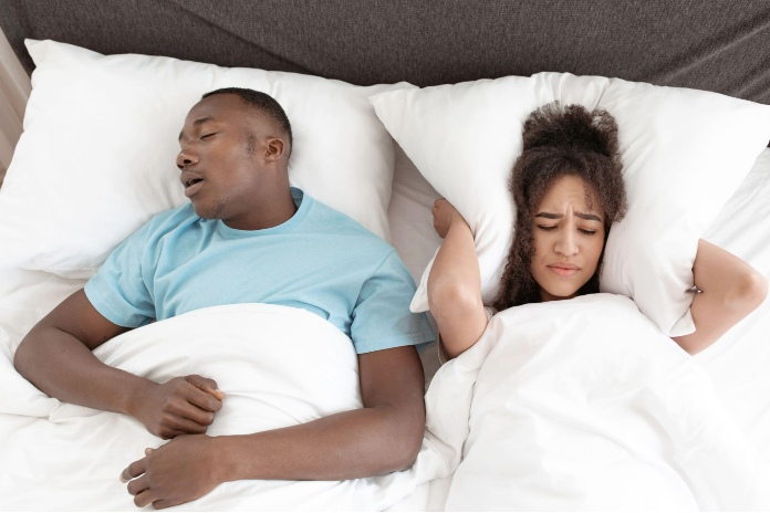 Couple in bed snoring