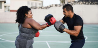 Spring fitness trend Woman boxing with a partner