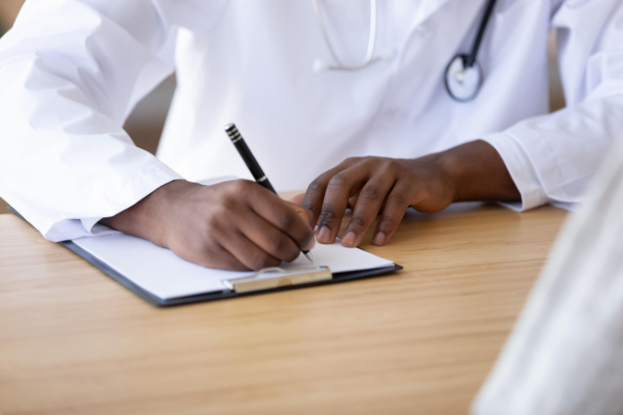 Doctor writing notes of sepsis symptoms