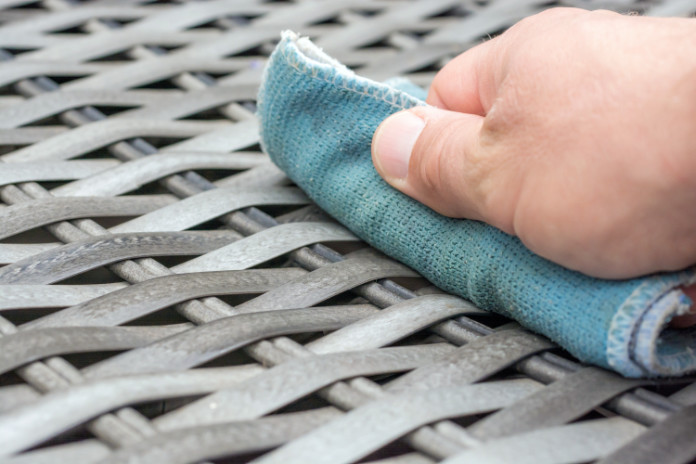 Cleaning wicker furniture with a damp cloth